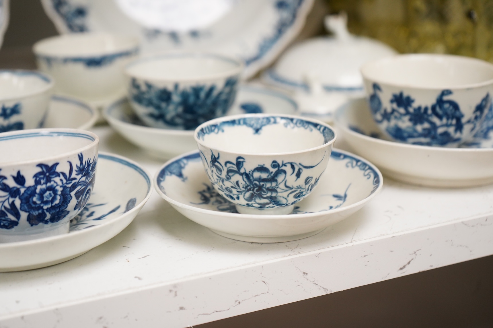 A collection of late 18th century Worcester, Caughley and Liverpool blue and white tea wares to include tea bowls and saucers, jug, suger basin and cover and two dishes etc, largest 23cm in diameter
